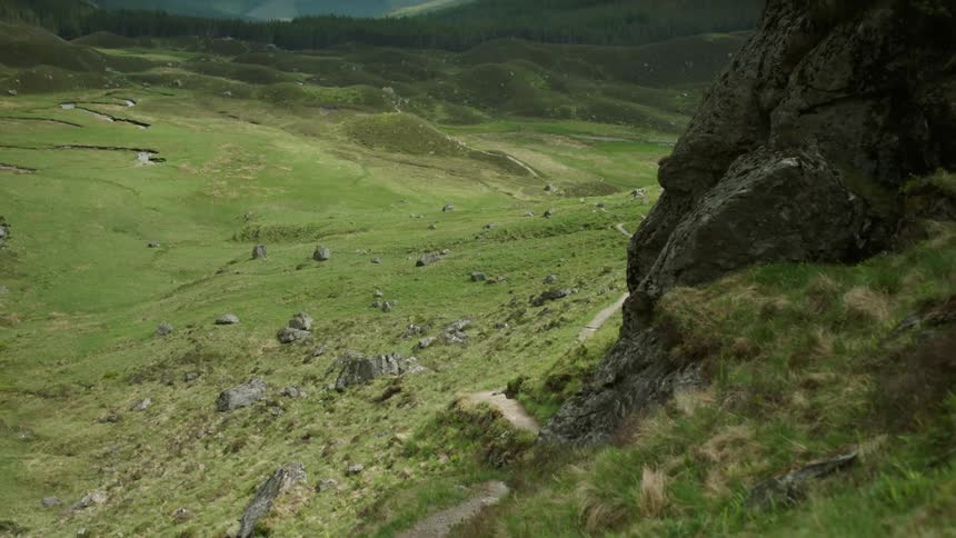 Grassy hillside and a valley on a cloudy day