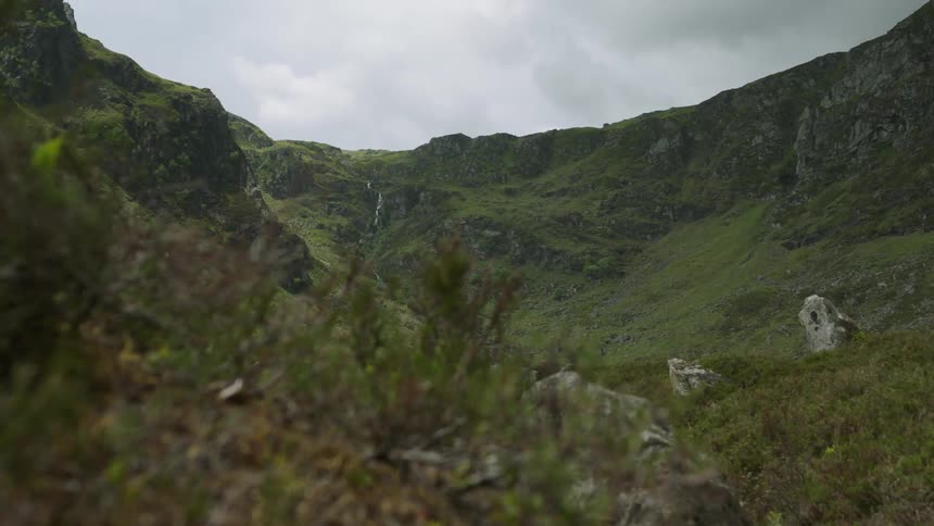 Clouds float over a mountain valley