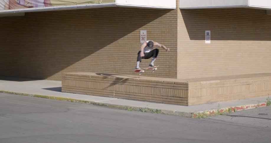 A man skateboards during the day