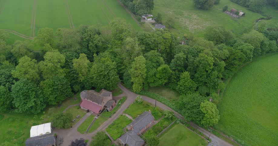 Rural buildings are surrounded by trees