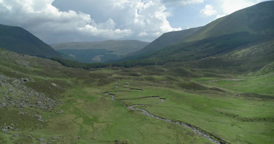 A stream runs through the mountain valley