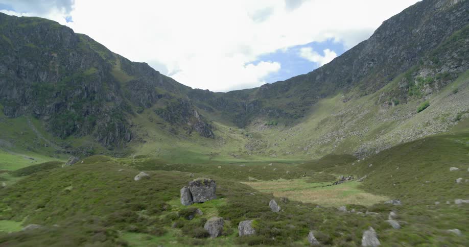 Clouds float over a mountain valley