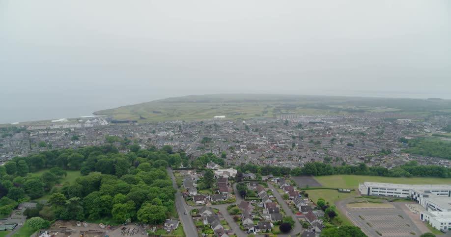A city is shown on a misty day