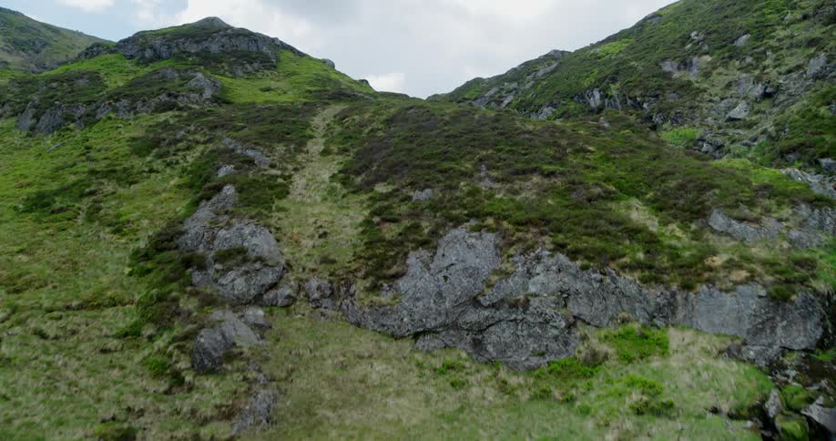A stream flows down a rocky mountainside