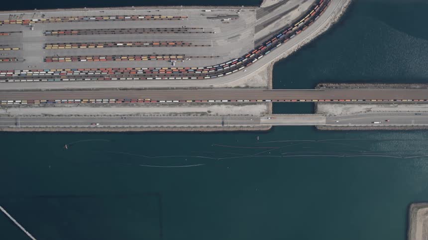 Cars drive on a waterfront road