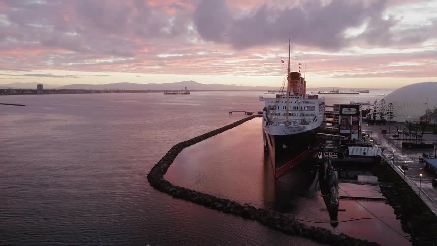 A large freighter boat sits docked in the water