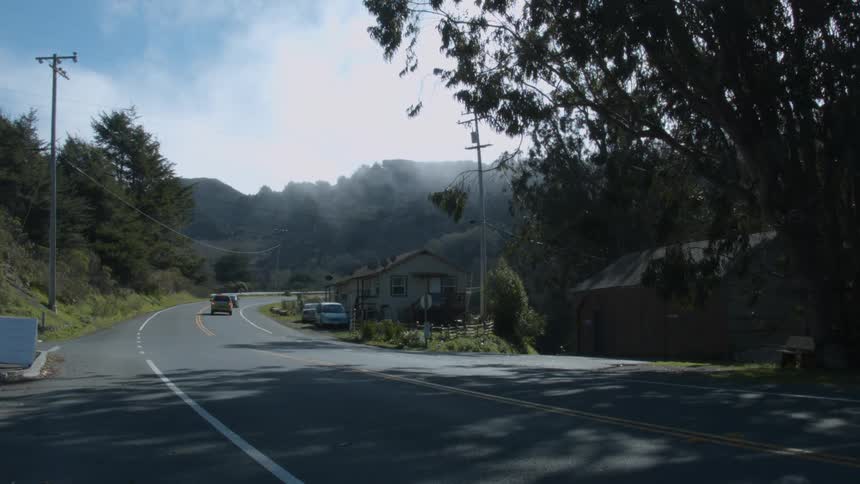 Cars drive on a town road