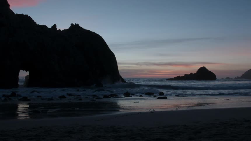 The tide flows onto the beach shore
