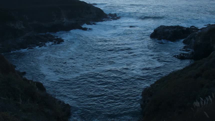 Water flows towards the rocky shore