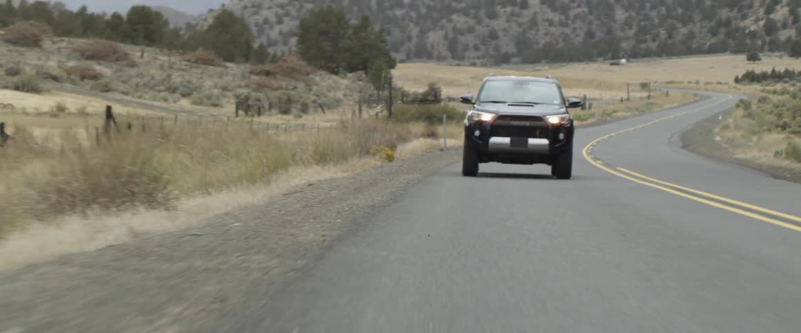 A vehicle moves down the long road