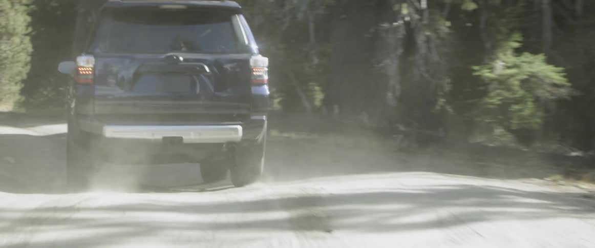 A truck drives on a dirt mountain road
