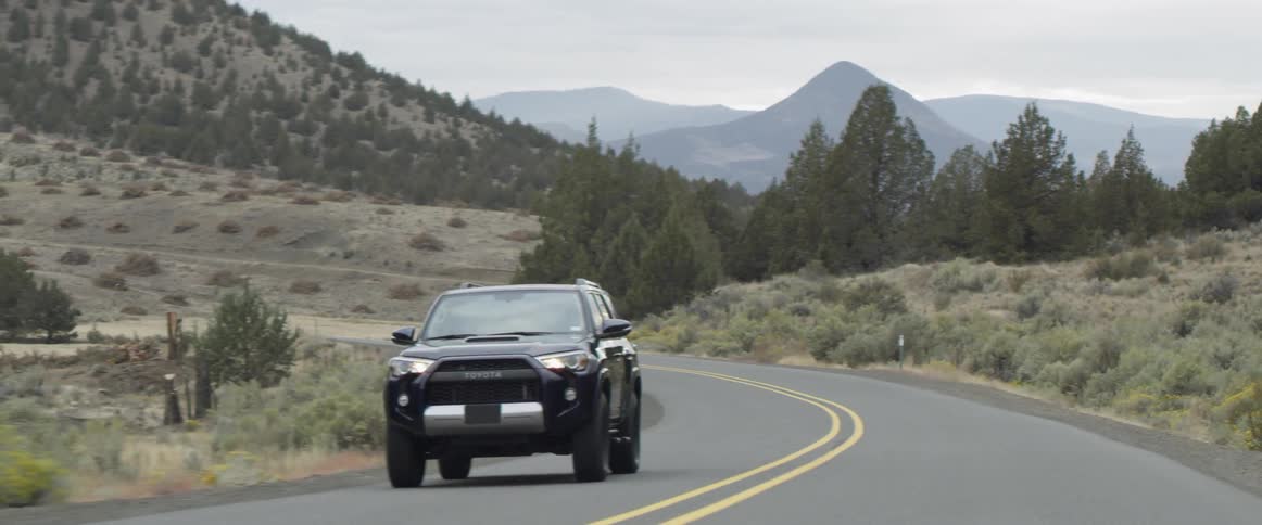 A truck drives down a mountain road