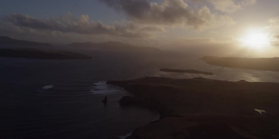 The sun sets over a coastal area