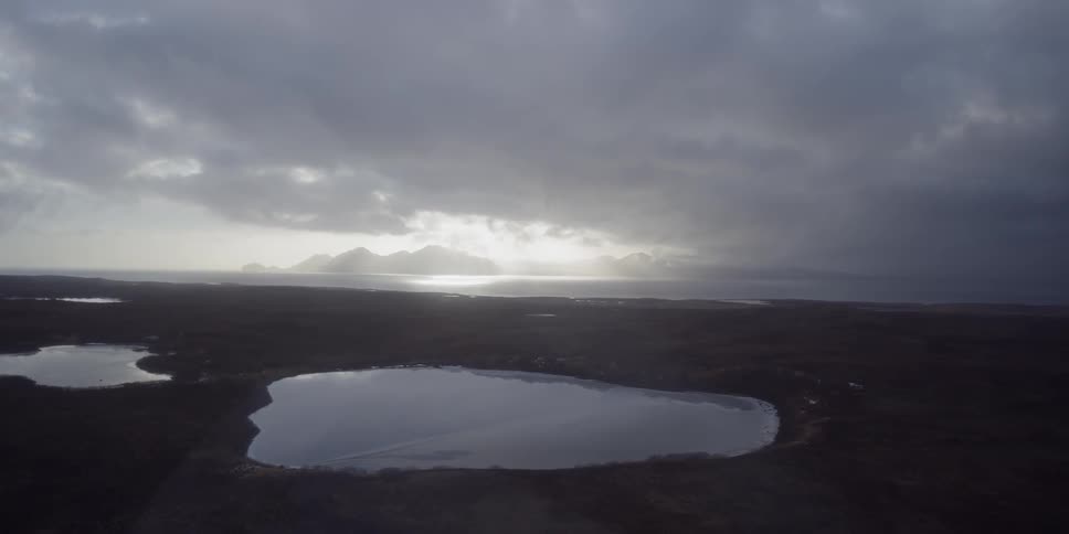 Clouds float over a mountain lake