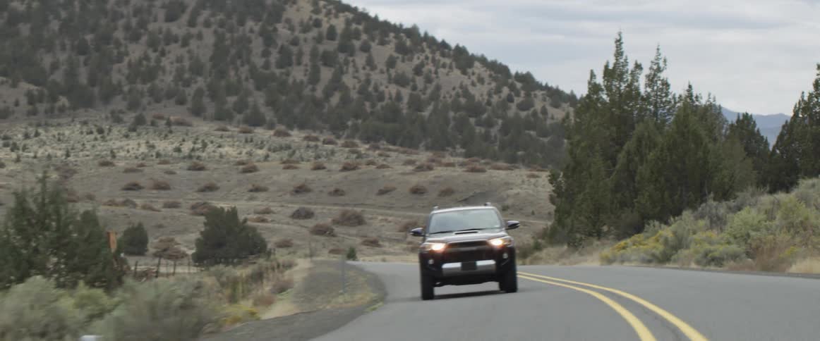 A truck drives down a mountain road