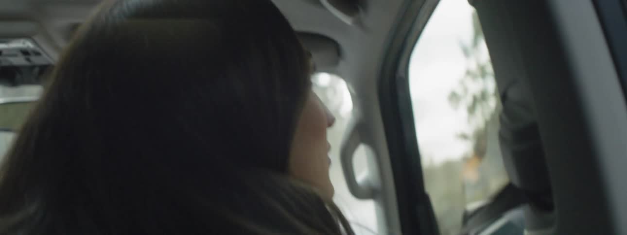 A woman rides in a car