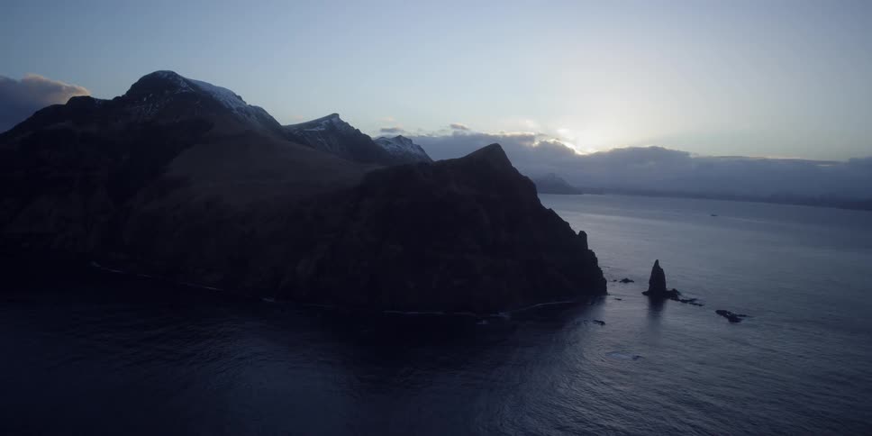 Water flows towards the mountain shore
