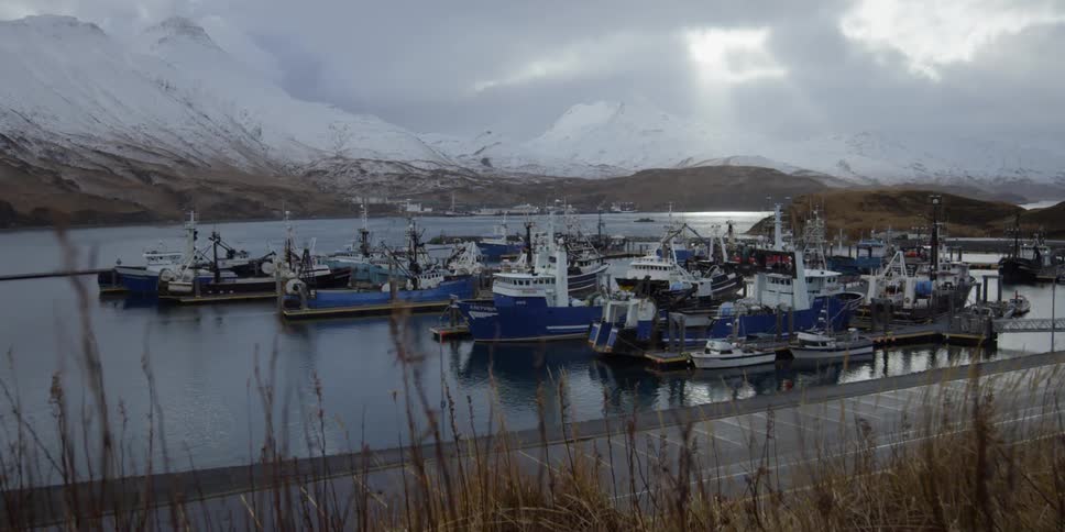 Many boats in a harbor on a cloudy day