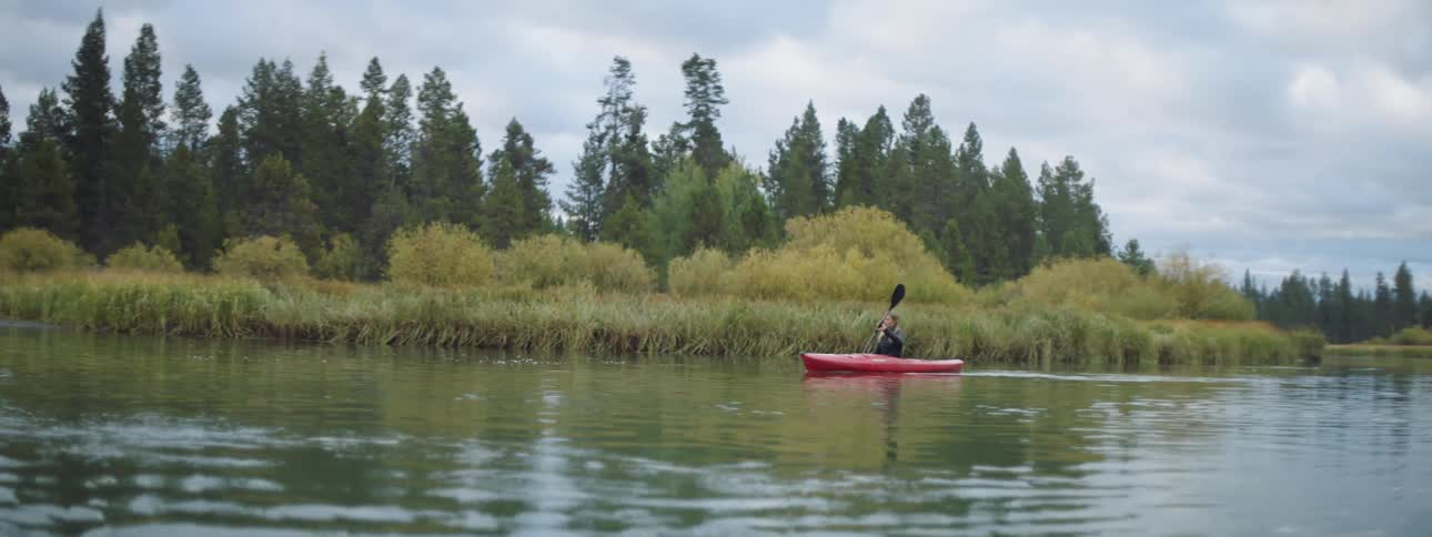 A woman kayaks on the water