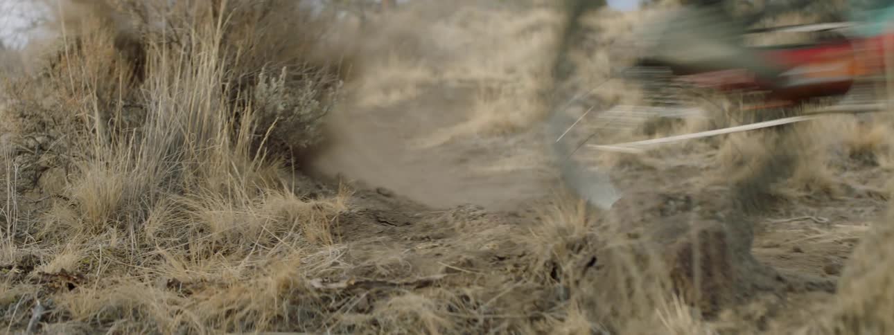 A bicyclist rides down a hillside