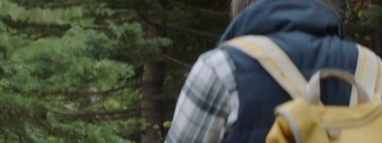 A woman is hiking in the forest