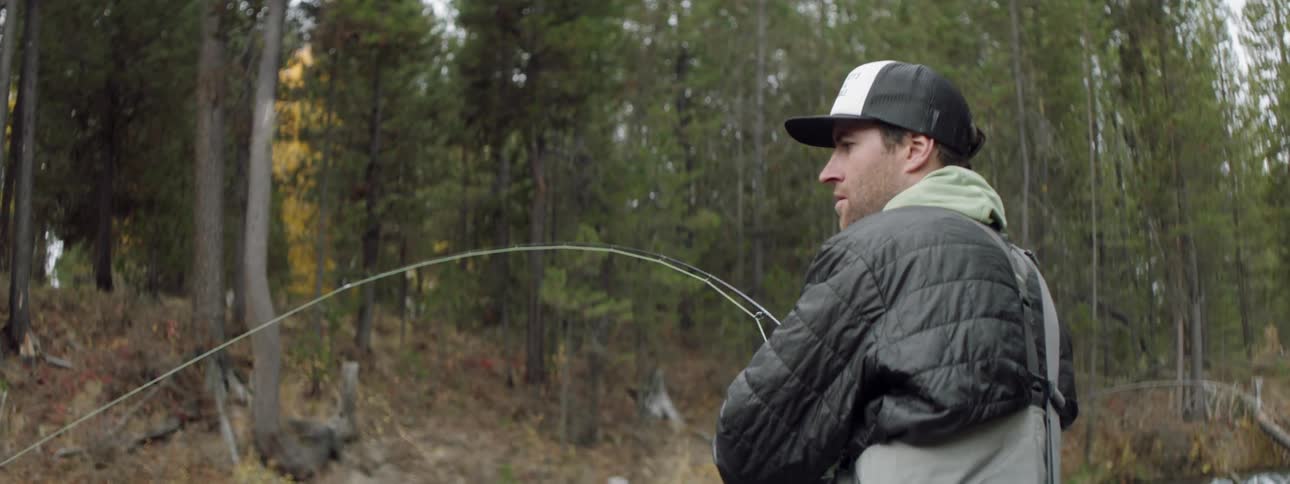 A man fishes in a stream