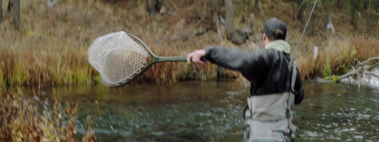 A man fishes in a river