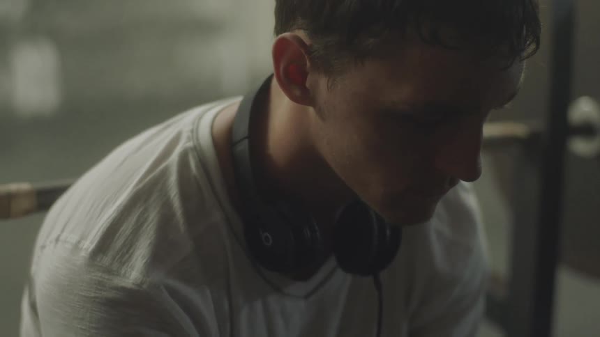 Man wearing headphones looking sullen