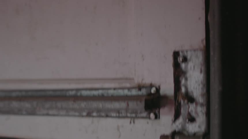 A garage door is being opened during the day