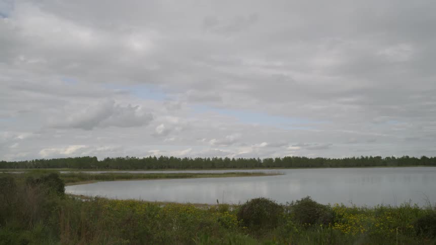 Gray clouds pass over a lake