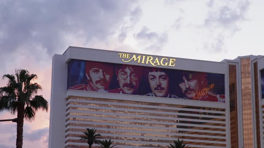 The tall building has a picture of the beatles at the top