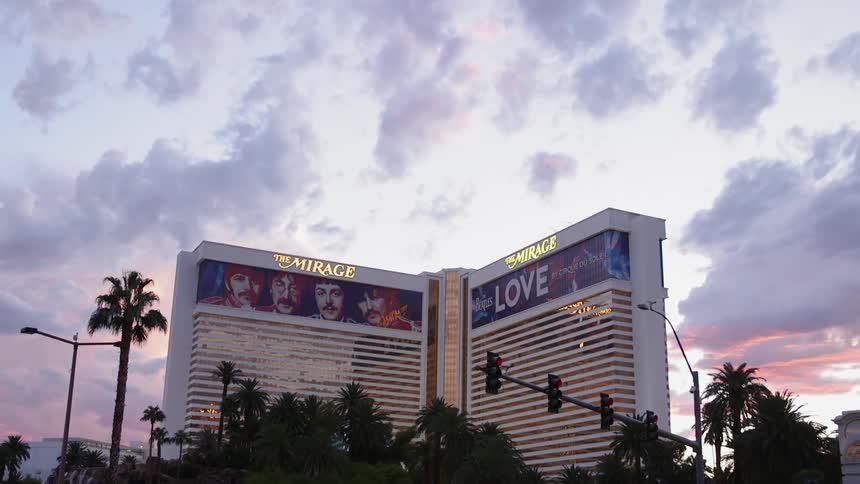 Clouds are hanging in the sky over a casino motel at dusk