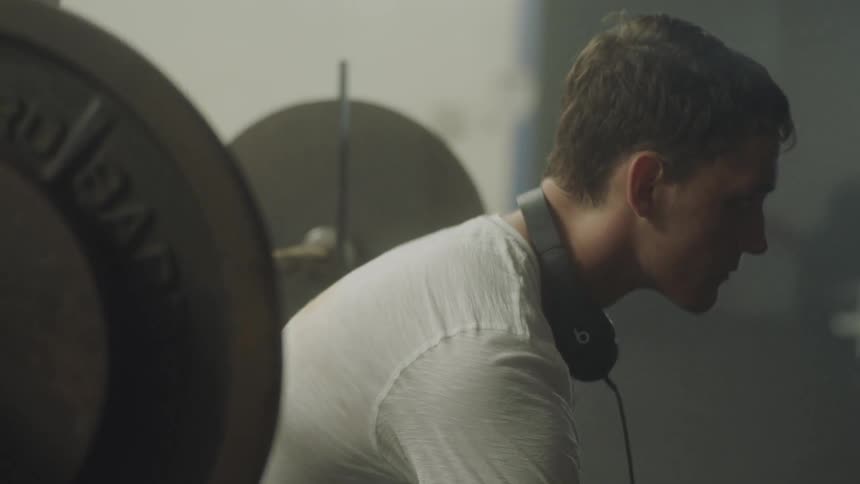A man sits on a weight bench