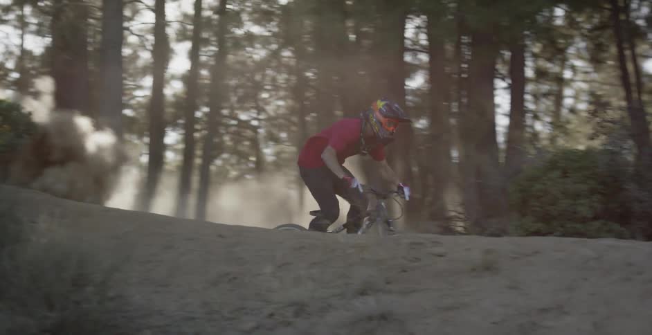 A person bikes on a dirt path