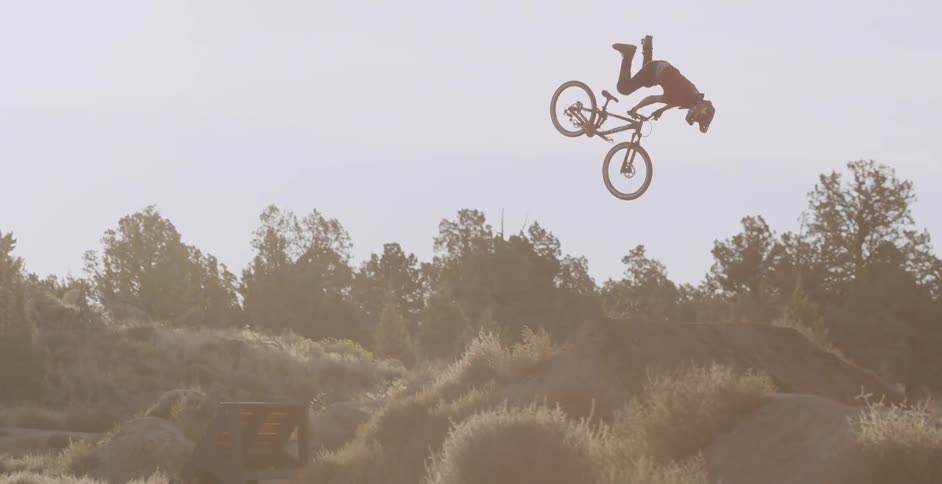 Cyclist performing some acrobatics in a hilly area