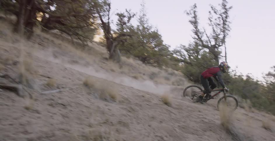 A bicyclist speeds down a hillside