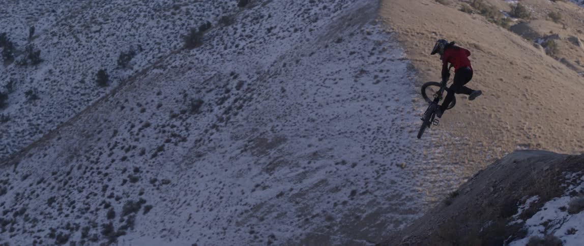 A man biking on a snowy hill