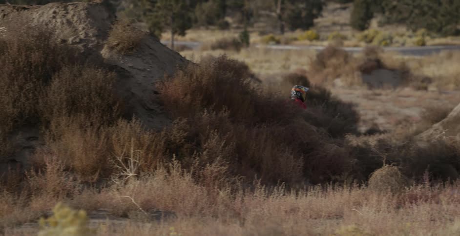 A man does a turn while jumping on a mountain bike