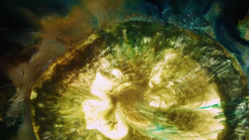 Glittery paint flows and swirls