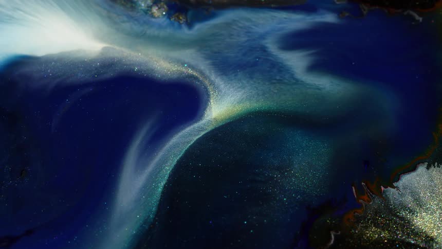 Glittery paint glistens and flows