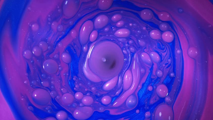Colors and patterns are swirling in a liquid solution