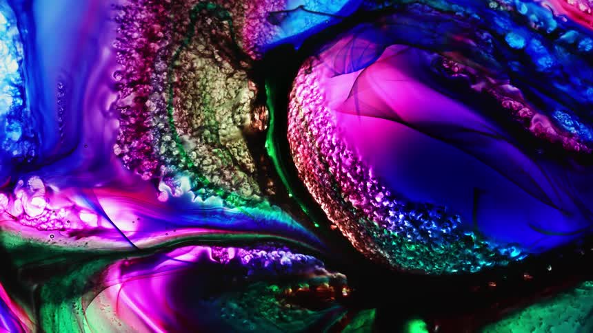 Multi-colored liquid rotates and swirls together