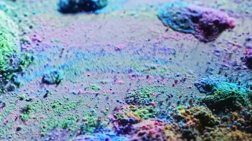 Colorful sand is being vibrated
