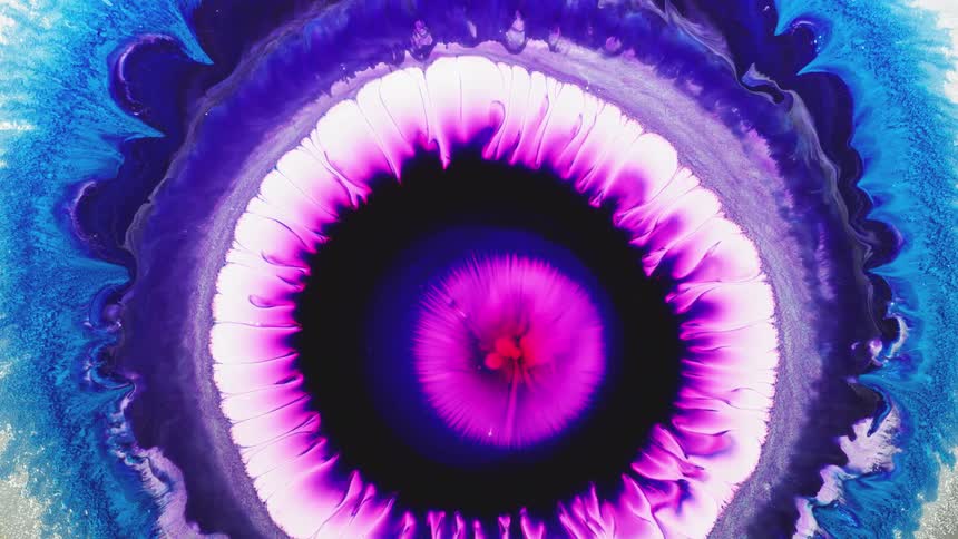 Multi-colored liquid rotates and swirls together