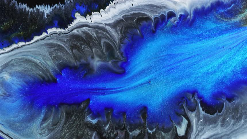 Glittery paint glistens and flows