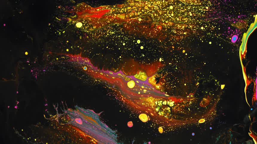 Colors are expanding in a liquid solution creating yellow dots