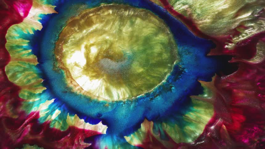 Multi-colored liquid rotates and swirls together