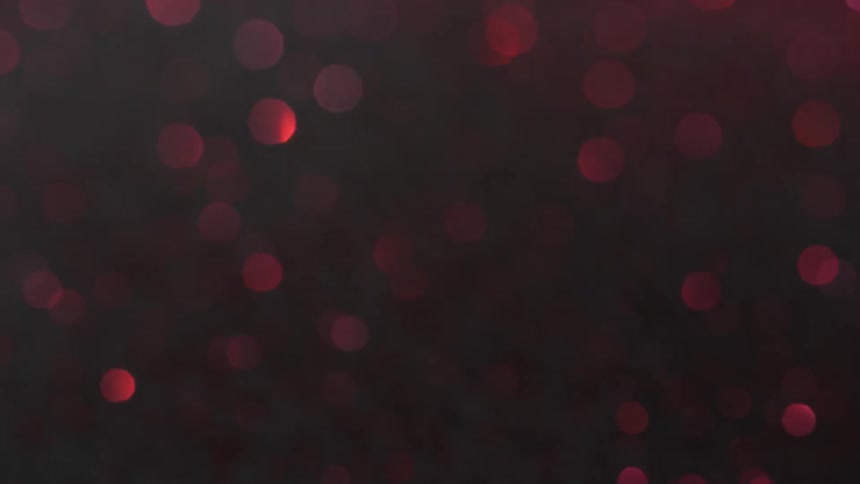 Red glitter in a magnetic solution creates shiny out of focus bokeh