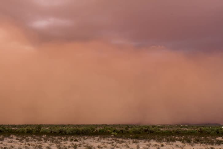 A dust storm approaches and engulfs a highway