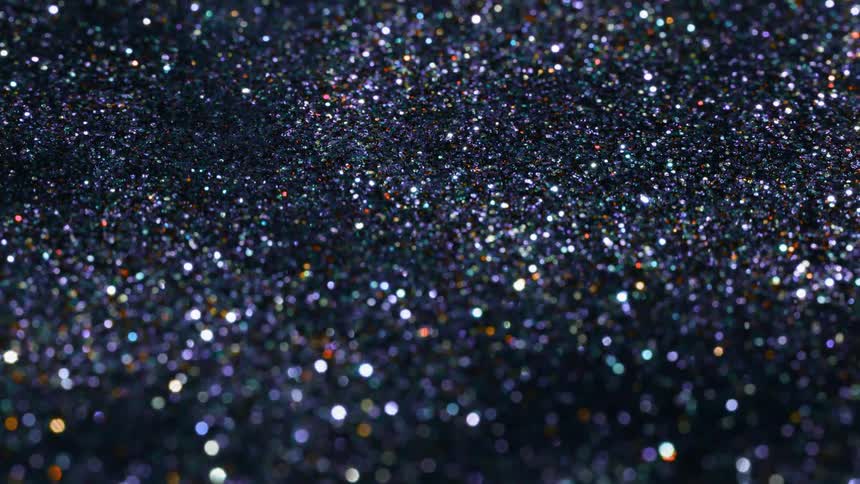 Shiny sparkling pebbles flow in a large pile